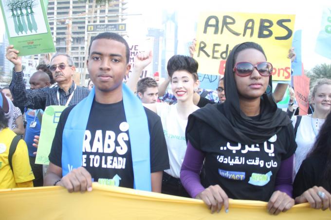 Climate activists march outside UN talks in Qatar 