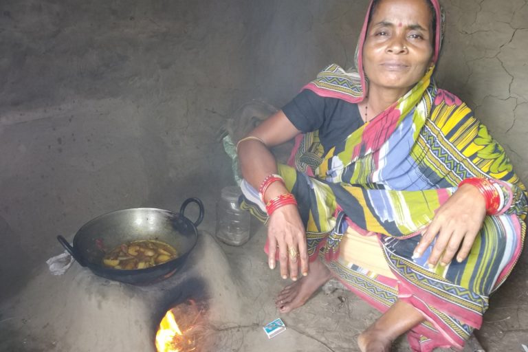 Woman cooking with firewood
