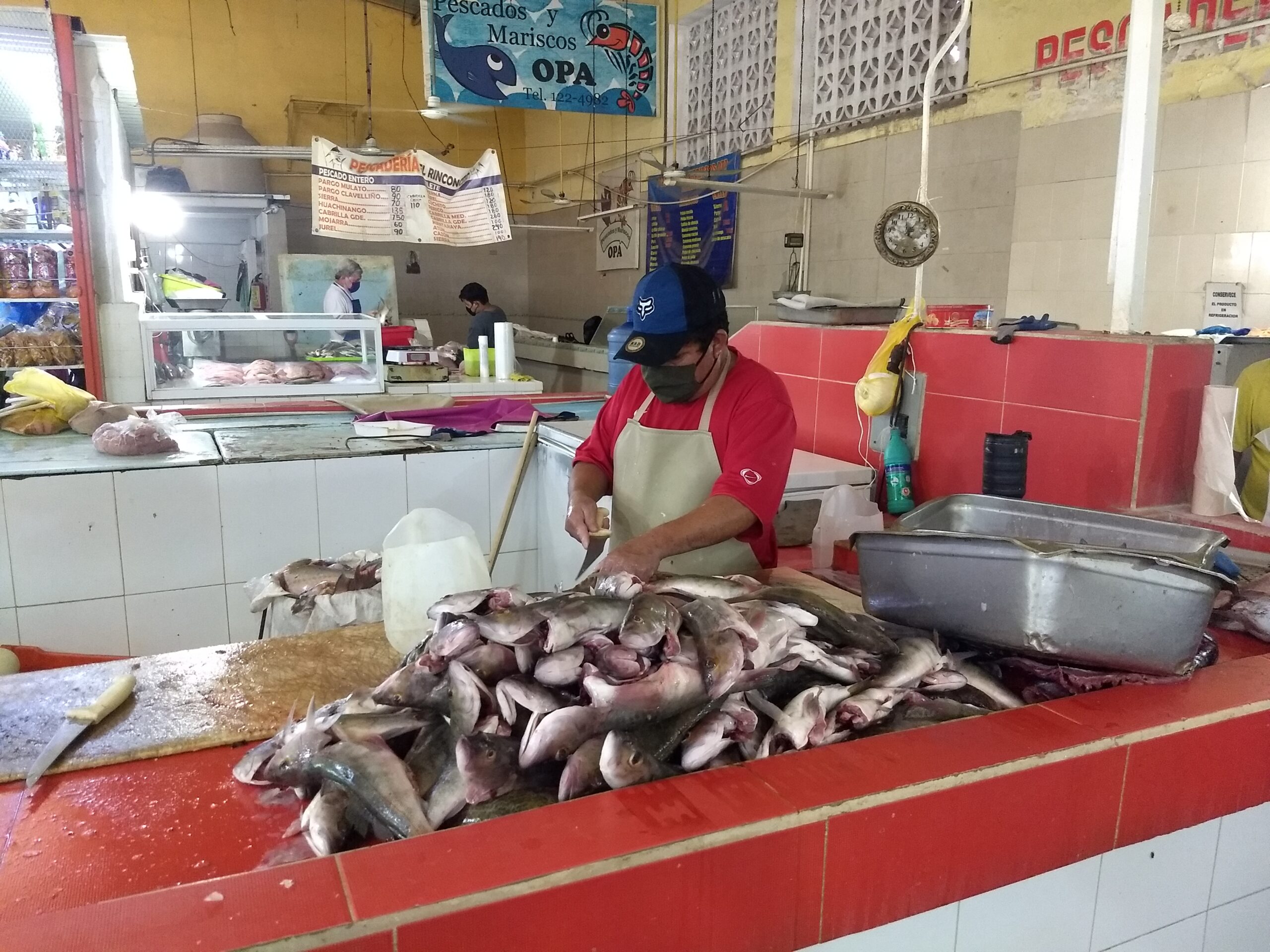 A man cleaning shark at a seafood market. 
