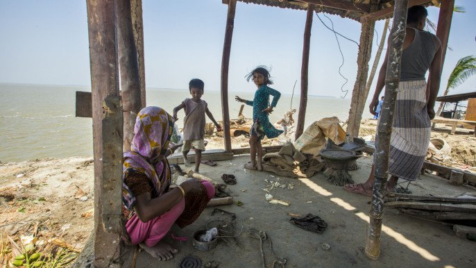 a family that was forced to leave their village due to sea level rise