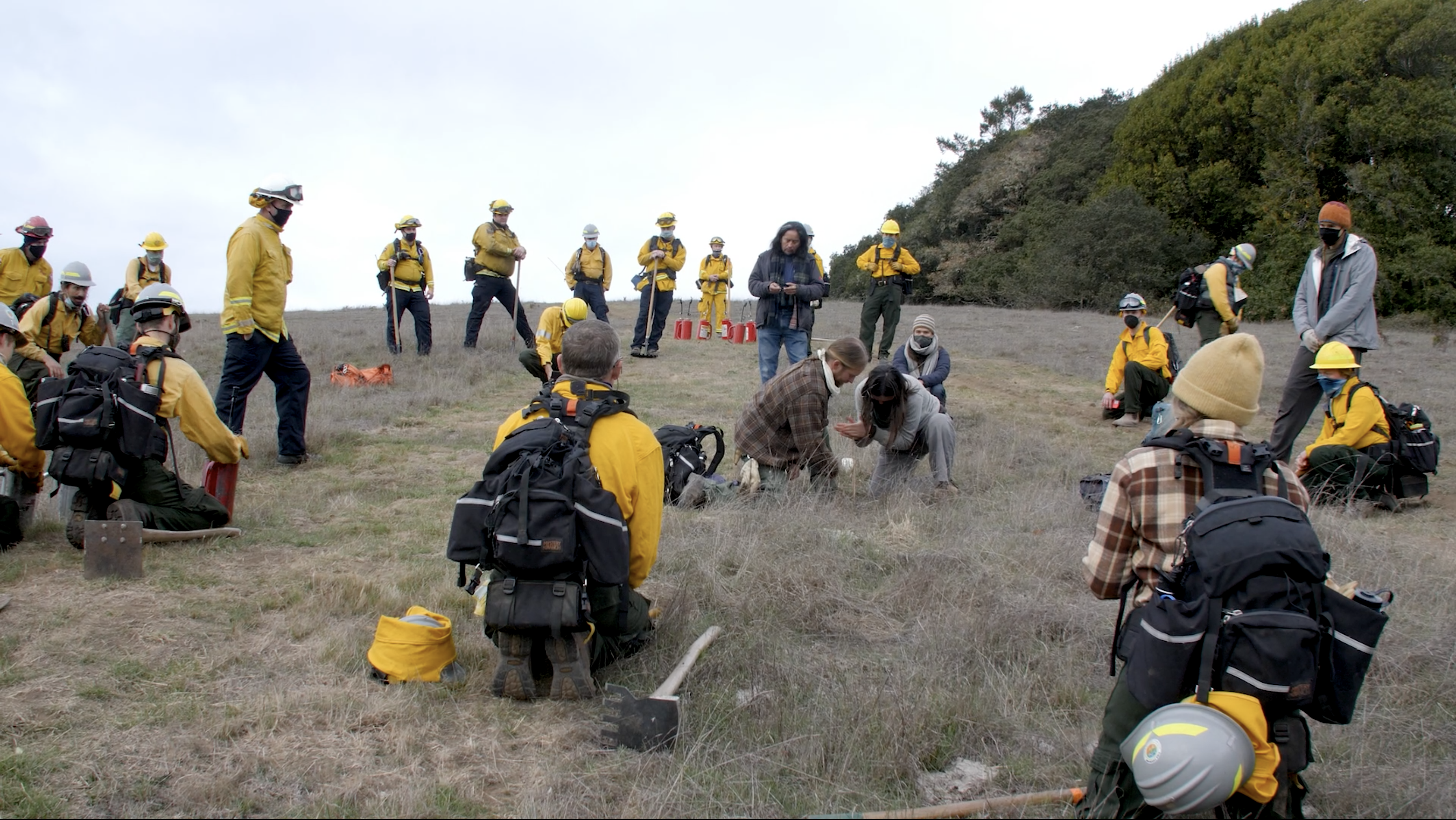 firefighers with Indigenous communities on a mountain top