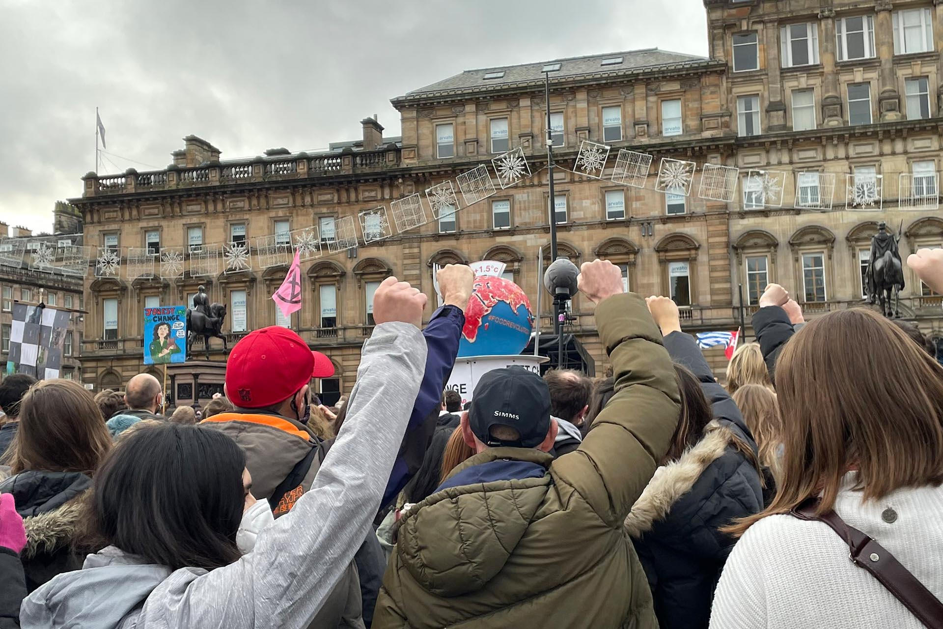 People raise their fist during a protest in Glasgow