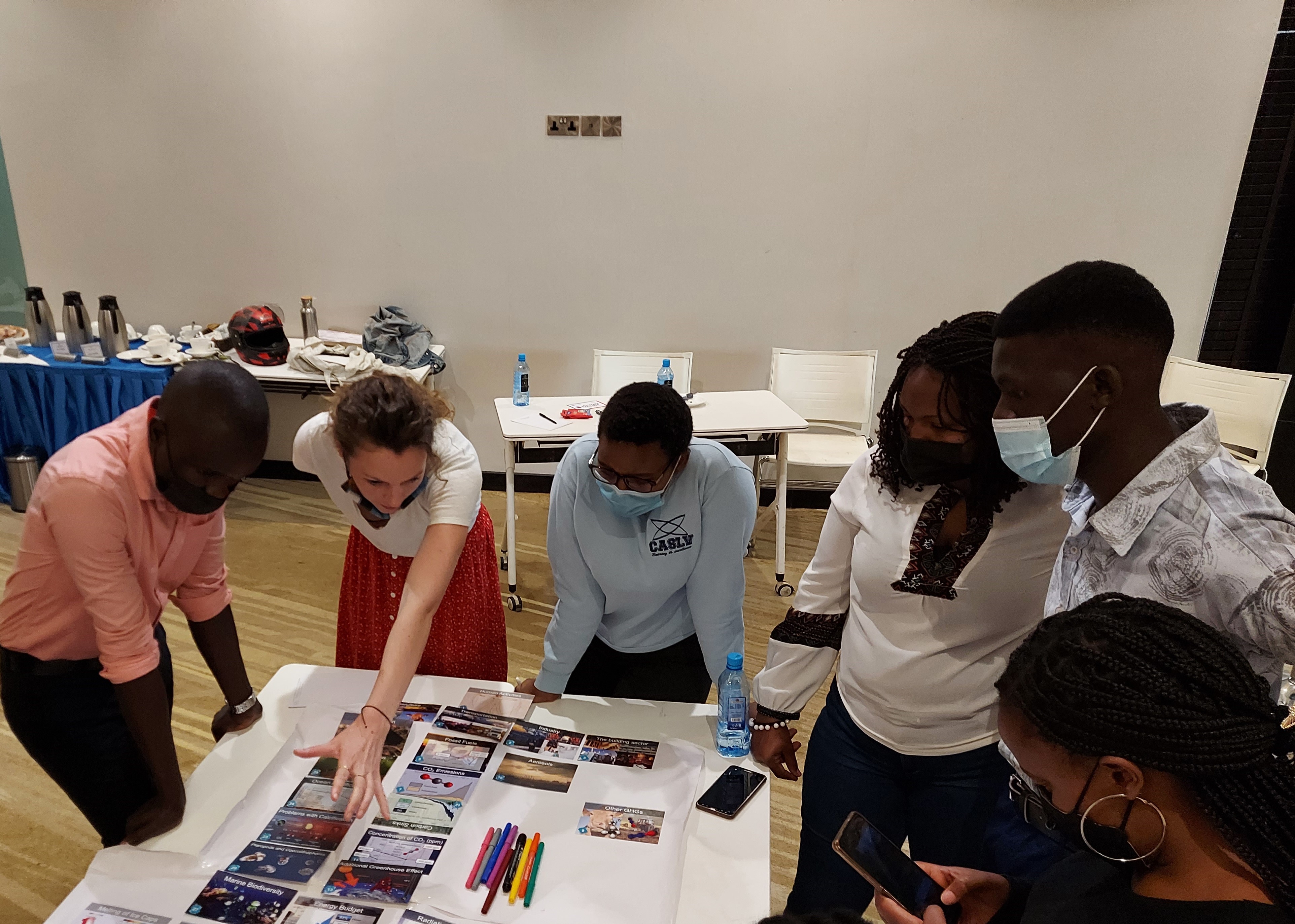 workshop participants study Climate Fresk cards