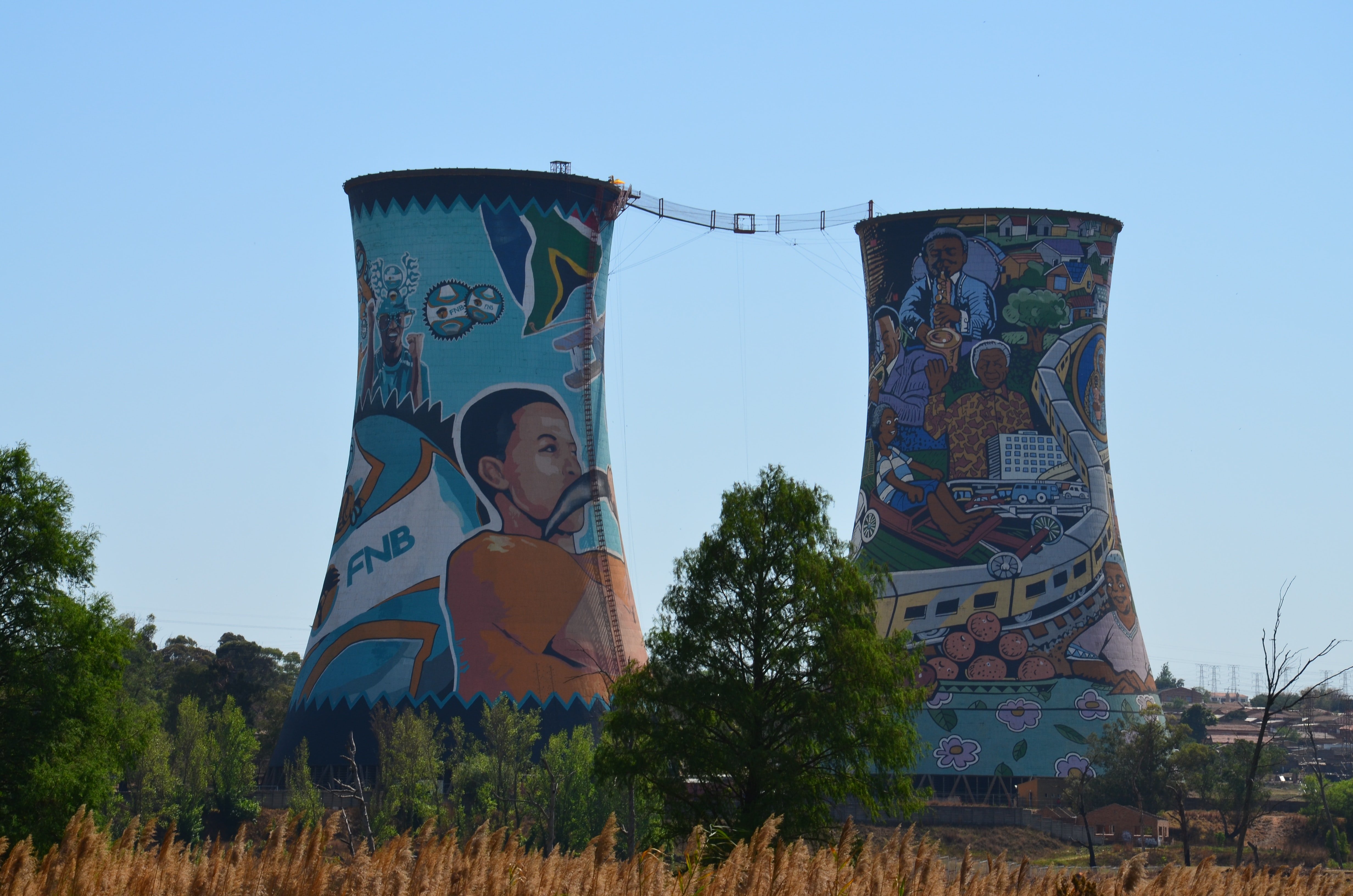 two cooling towers with street art