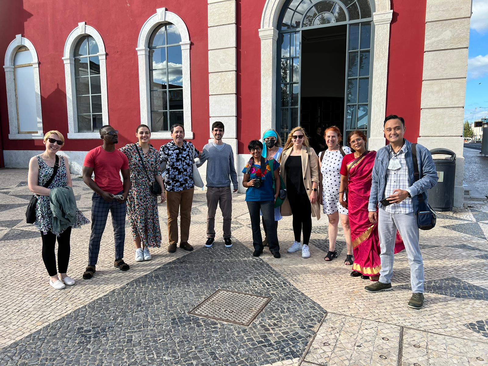 fellows in Lisbon in front of a red building