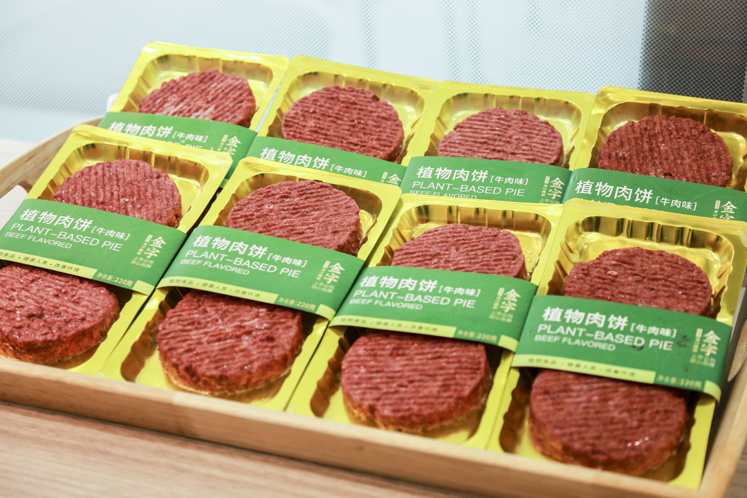 a line of plant-based burger patties 