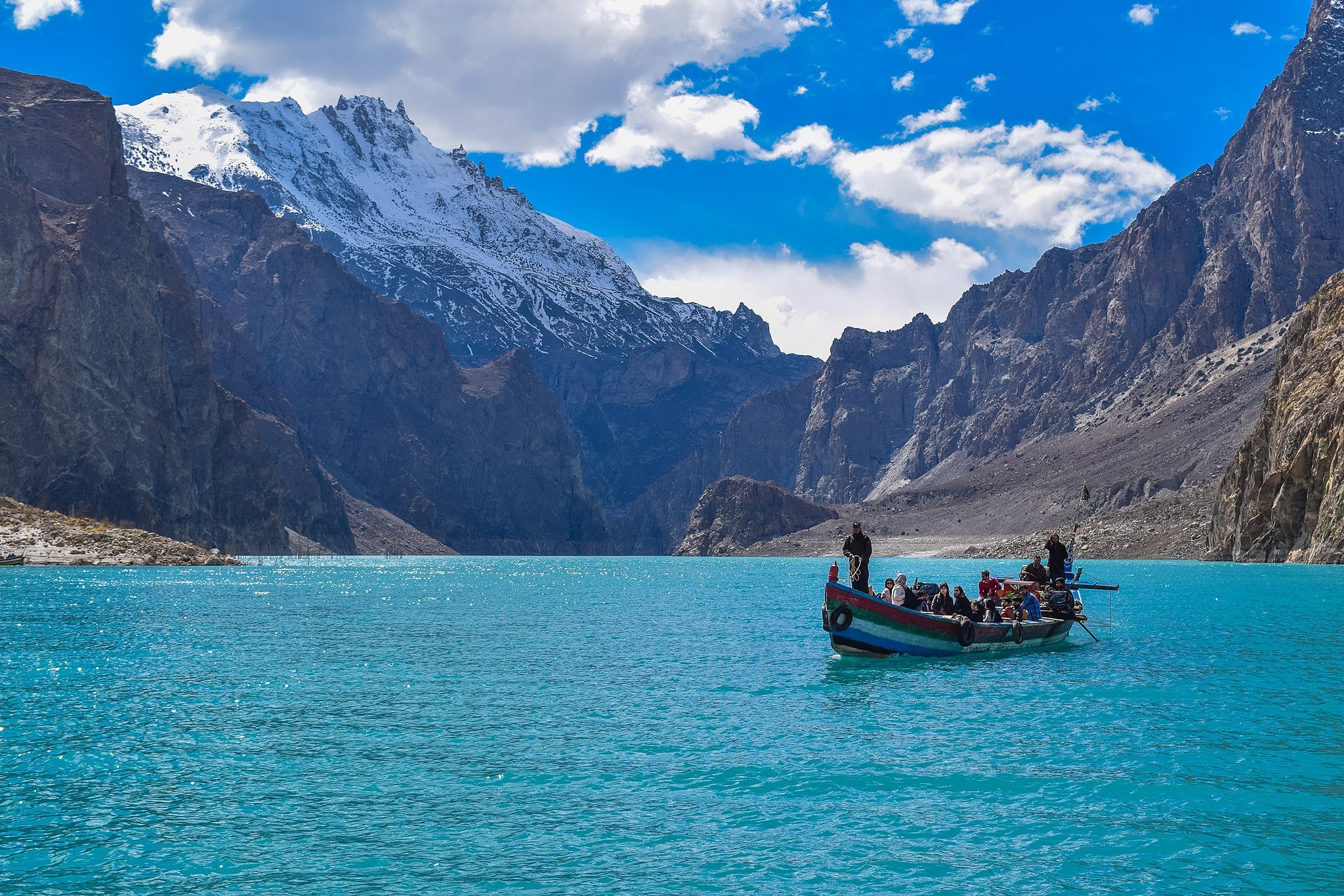 a boat on a lake with mountains in the background