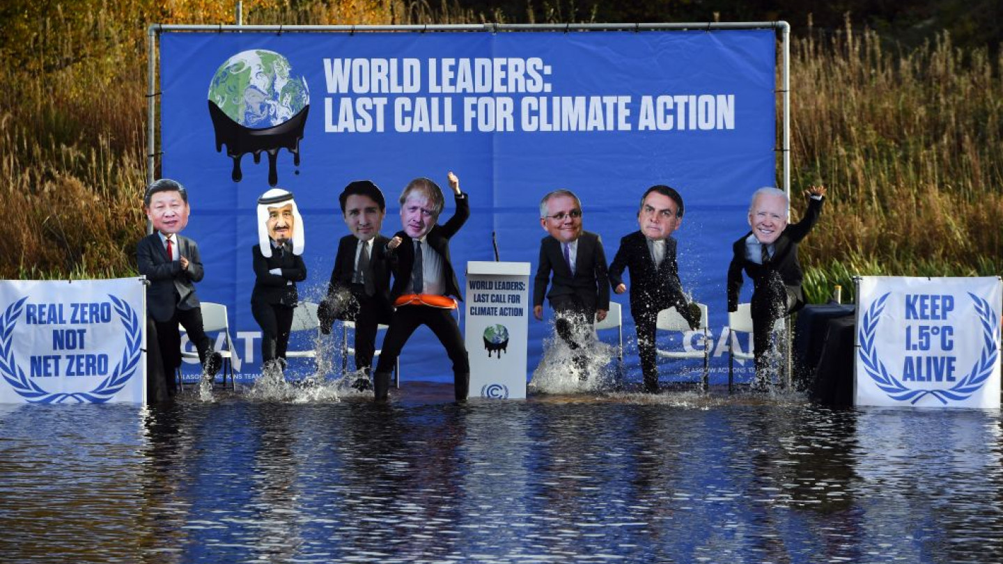 climate activists dressed as world leaders on stage