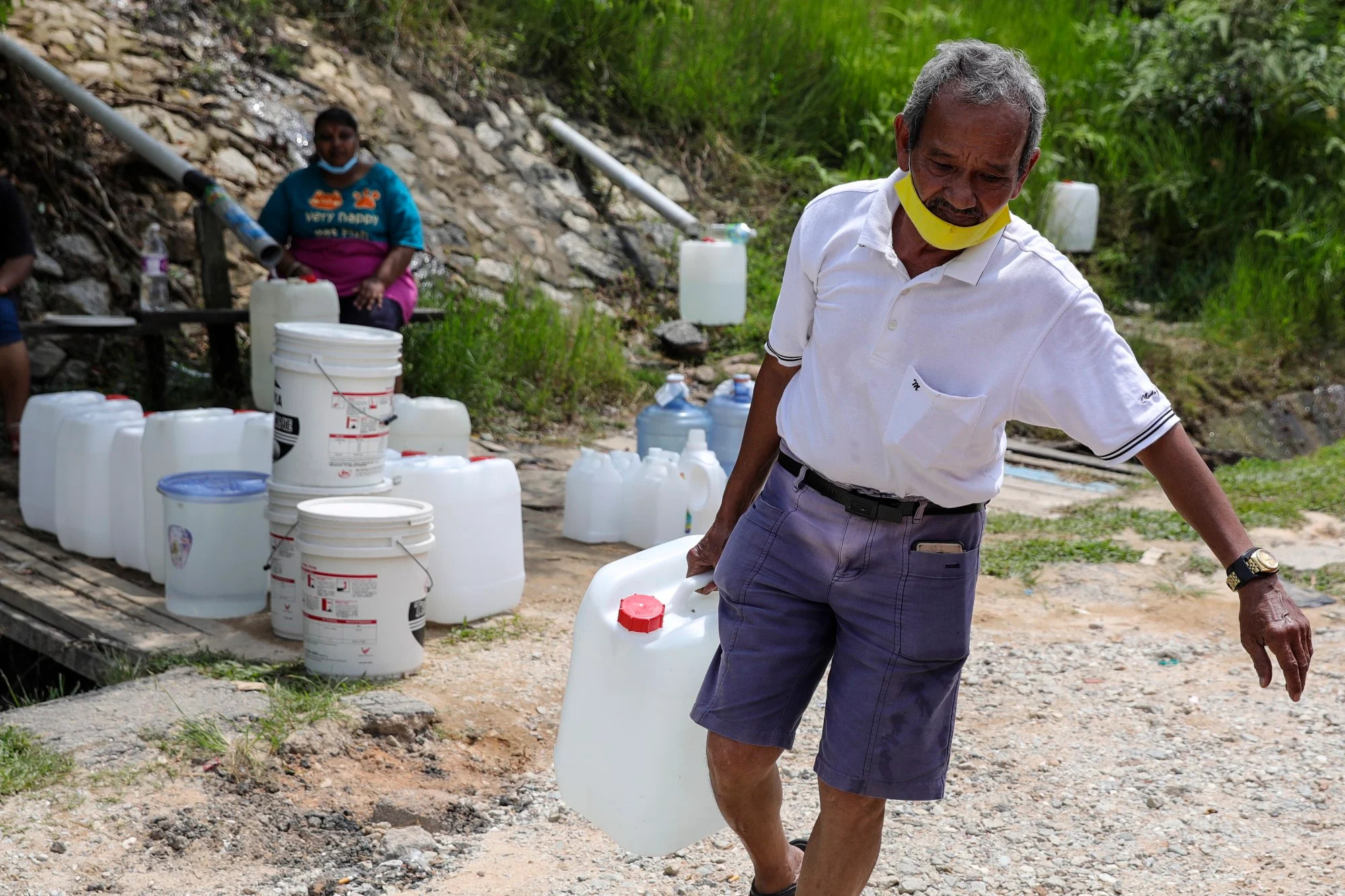 Person carrying water container
