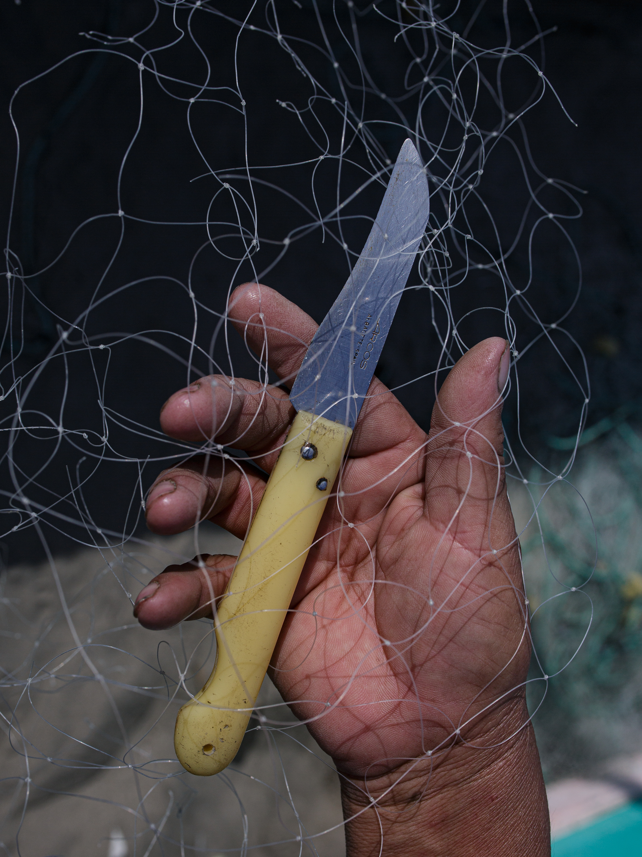 knife held near net