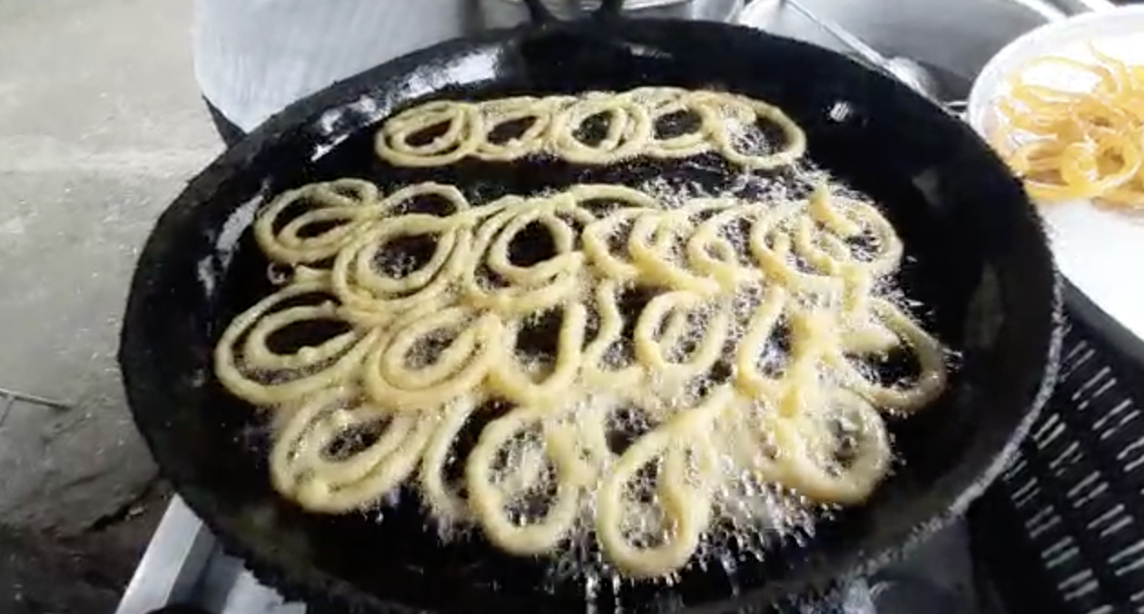 An Indian snack being fried in cooking oil that may be used. 