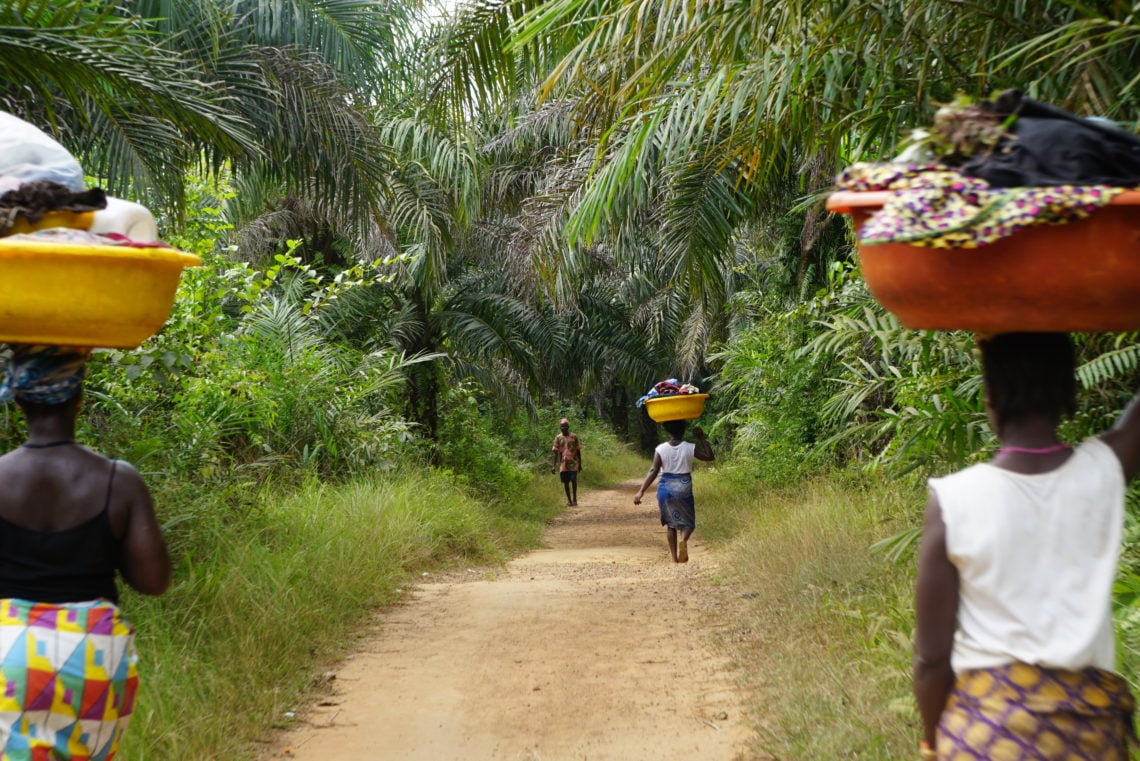 Women carry clothes along the road