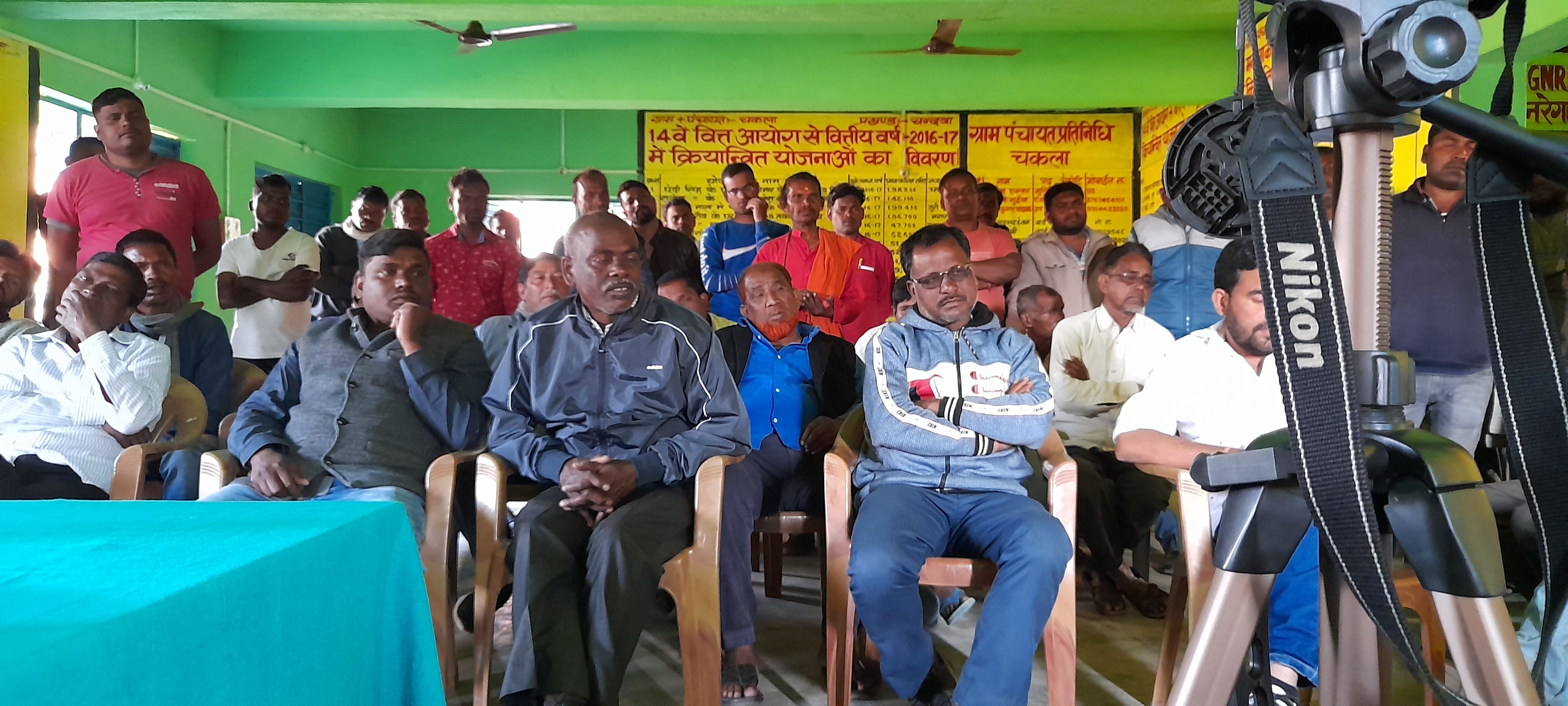 a group of men seated at a local panchayat meeting