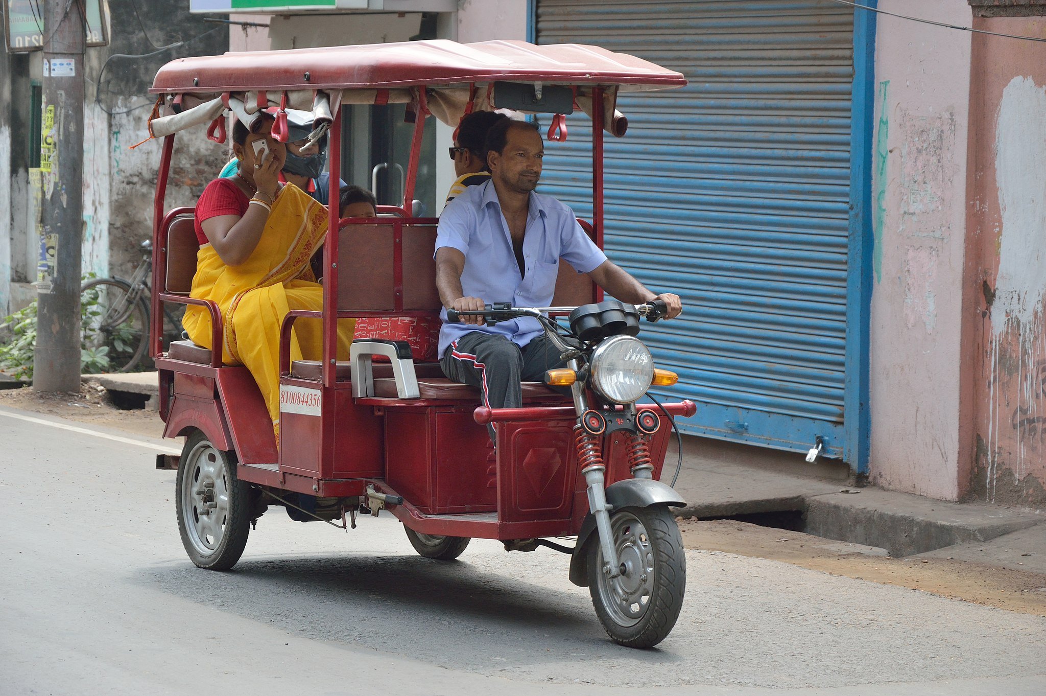 A rickshaw transports people