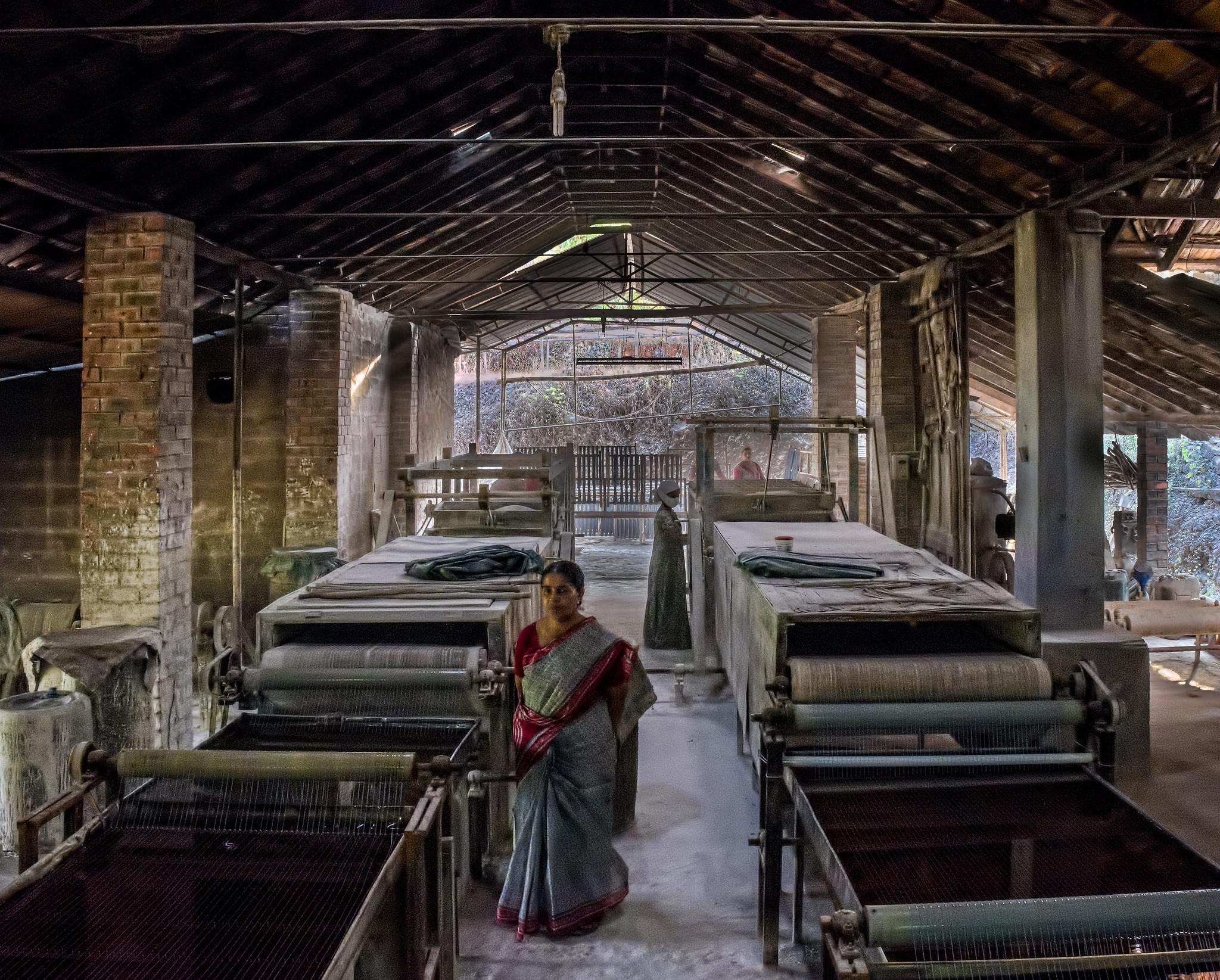 A woman in a sari in a rubber factory in India