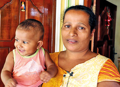 A woman holding a small baby