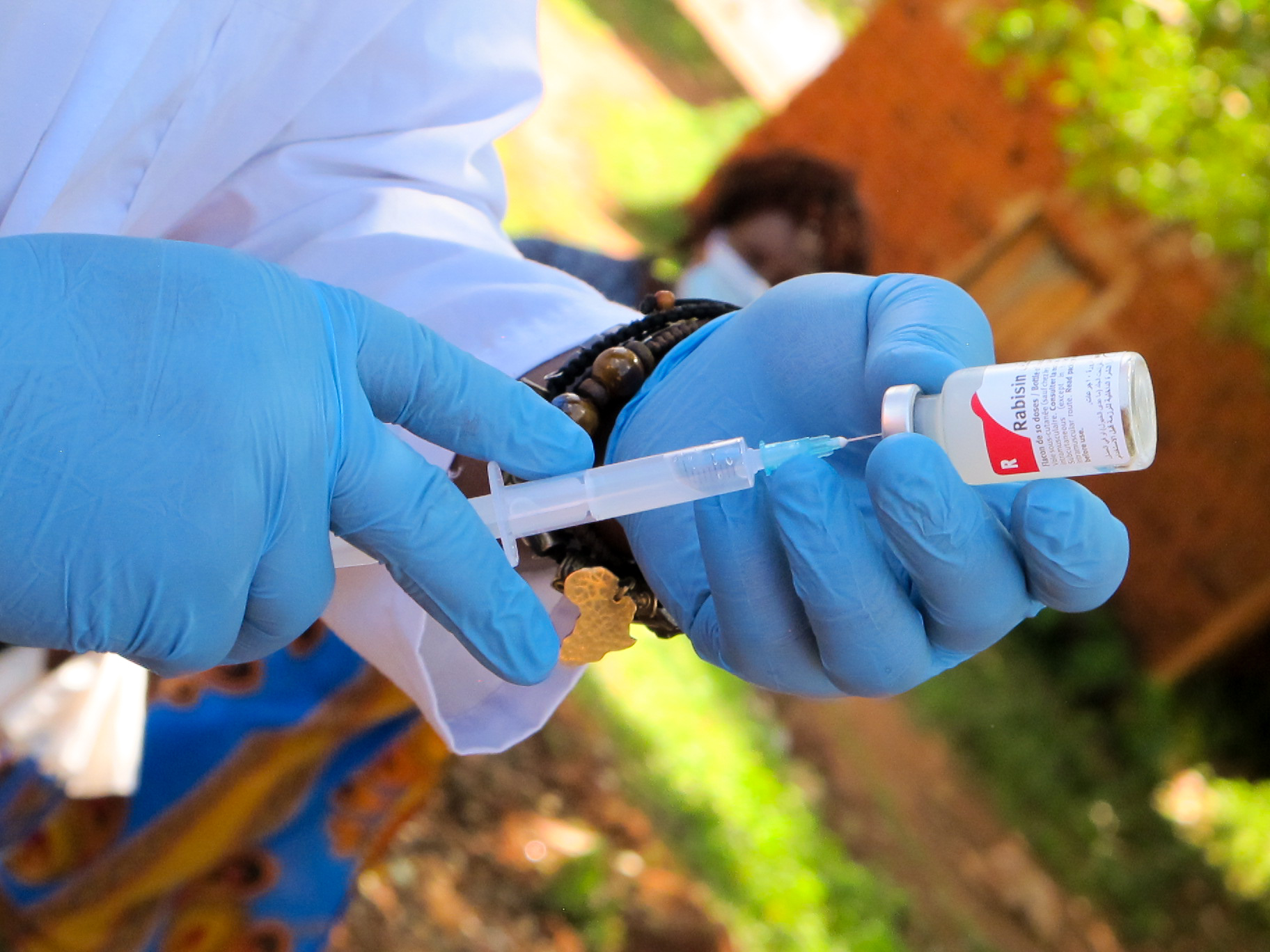 Rabies vaccine being prepared by gloved hands