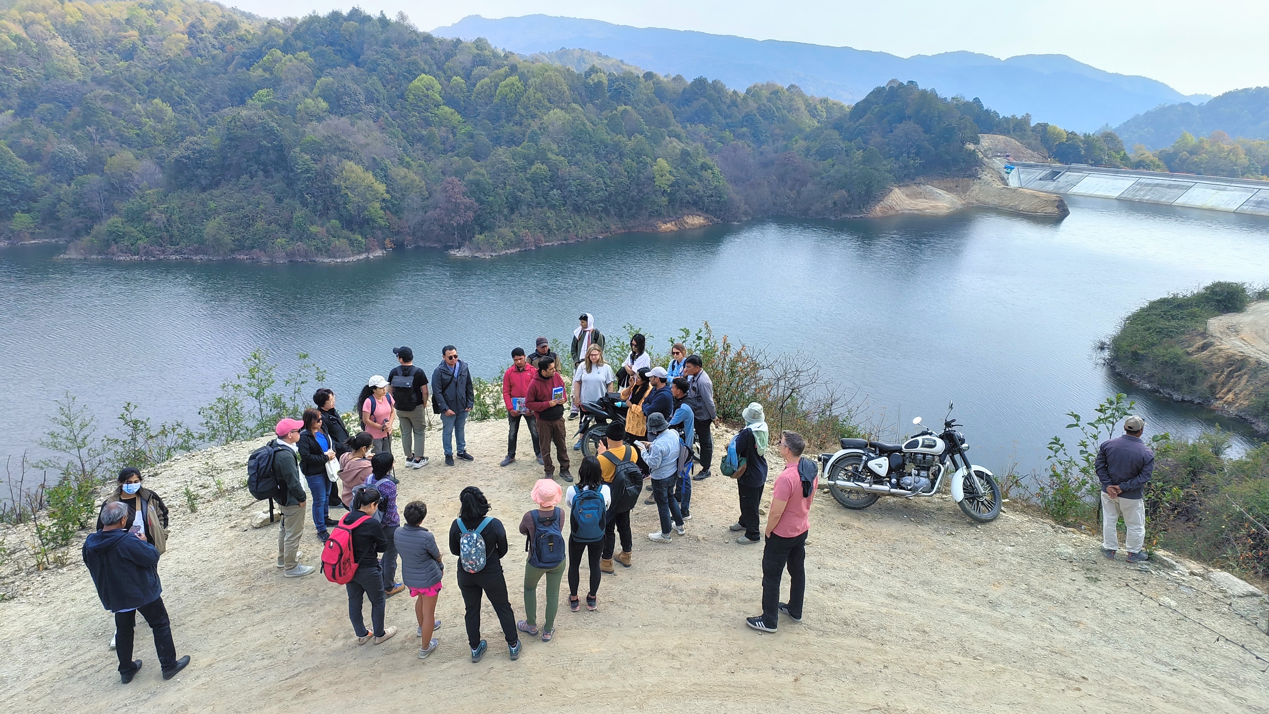 Participants interacting with Nischal Chatkuli, engineer at the Dhap Dam Project site, during the field trip to Shivapuri Nagarjun National Park / Credit: Michael Salzwedel. 
