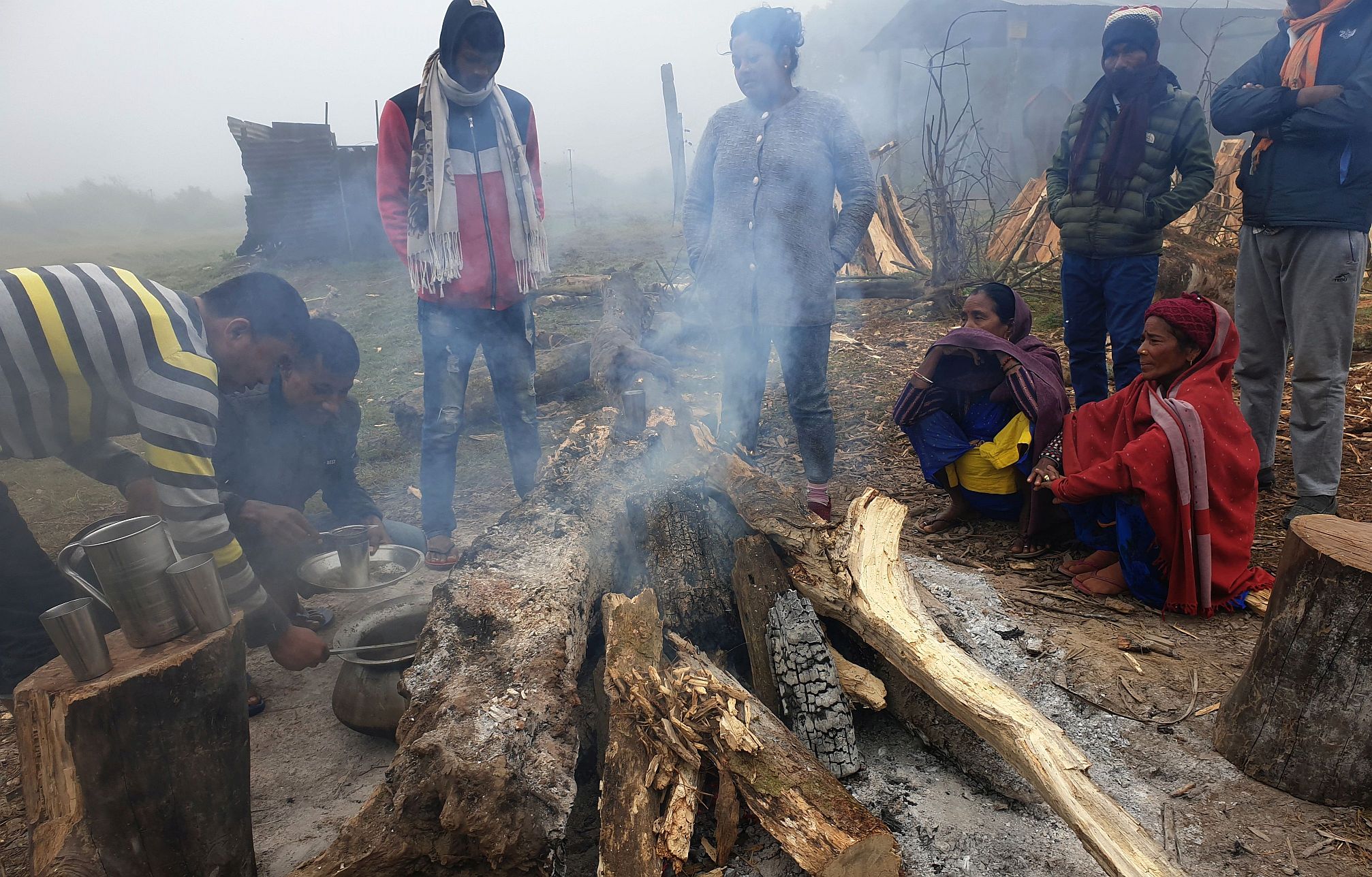 People warm themselves by a fire in Nepal