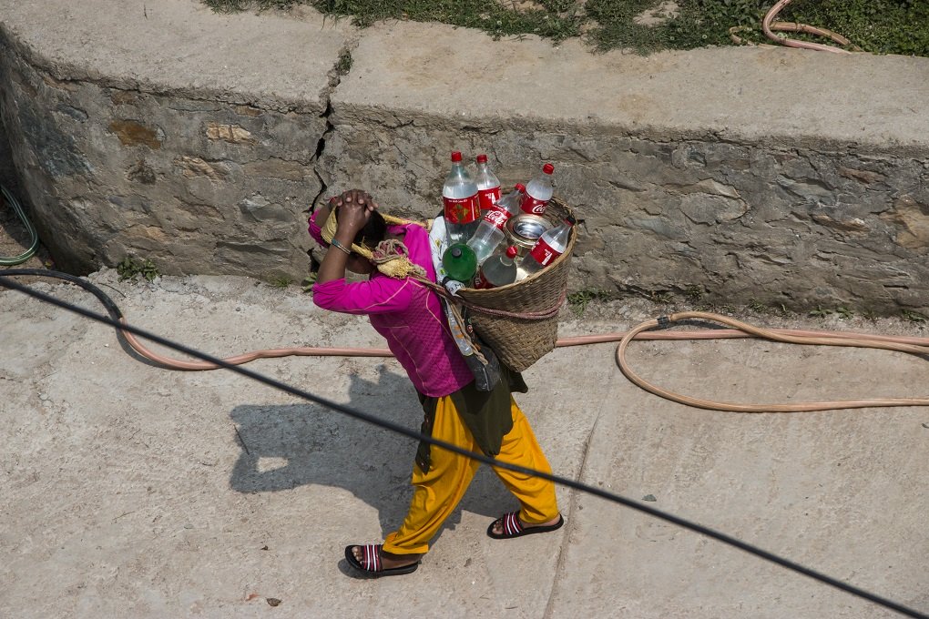 Woman carrying water bottles to fill