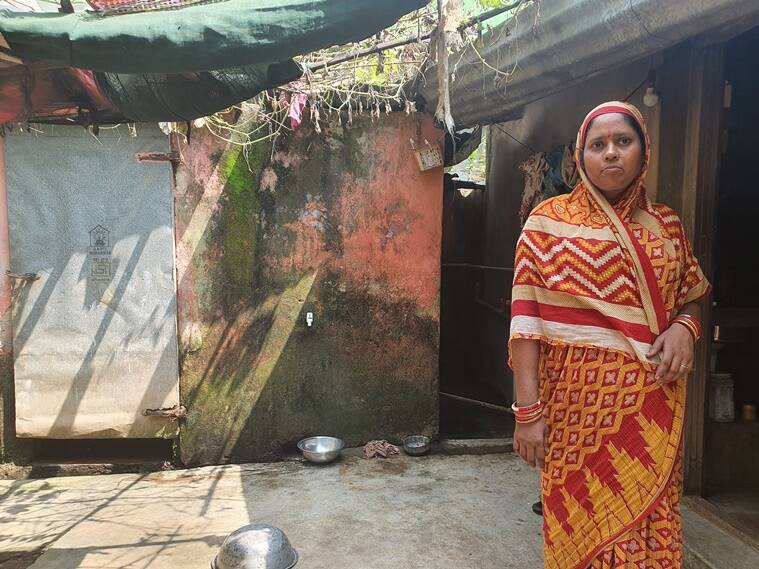 a woman stands outside her house