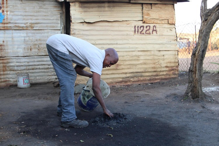 A man collecting duff coal 