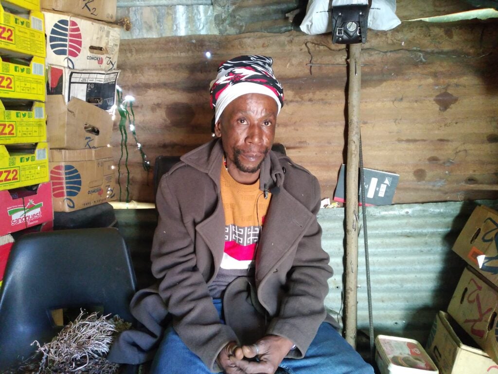 Monaheng Lekhooana, an informal trader who specialises in traditional medicine practice, sits in his consulting shack in Maseru. (Cred: Pascalinah Kabi)
