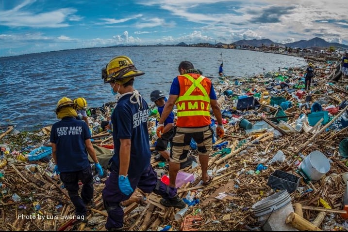 men searching through debris after a typhoon