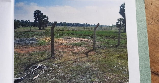 empty field with fence posts