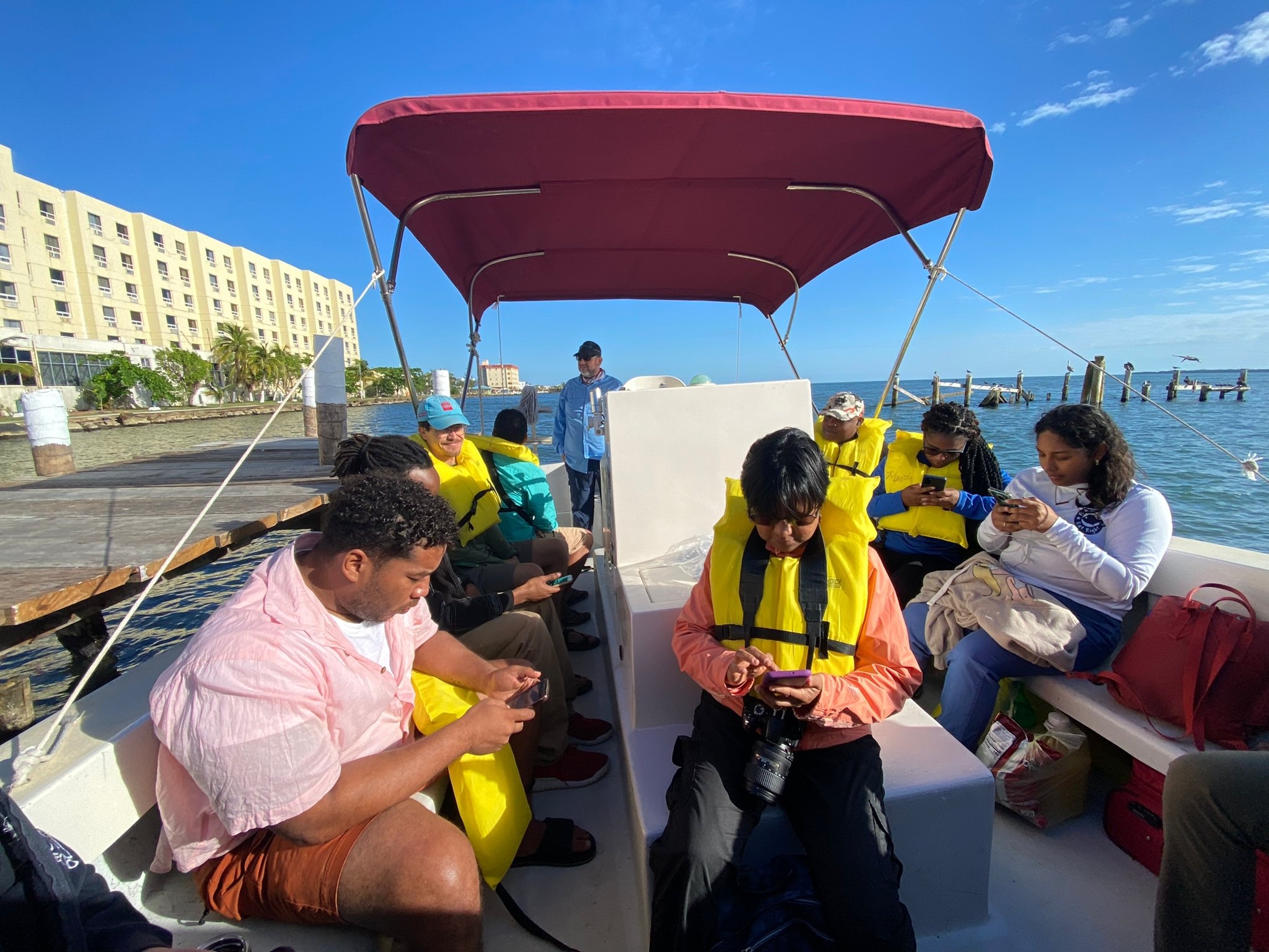 people seated on a boat in life jackets