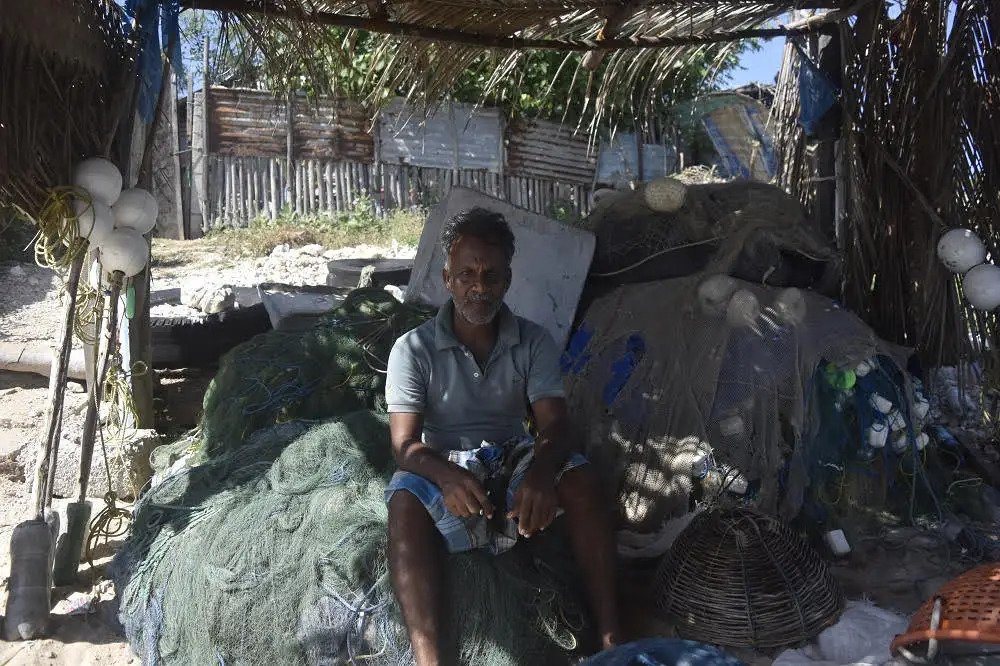 a fisherman seated near his nets