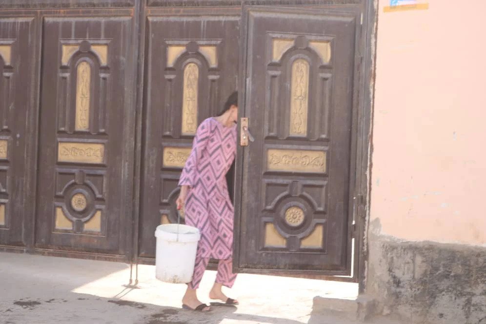 A woman in Tajikistan's capital with water