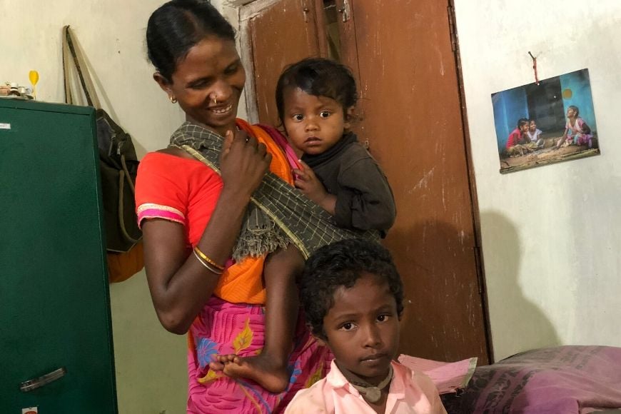 A mother and her two young children at the clinic