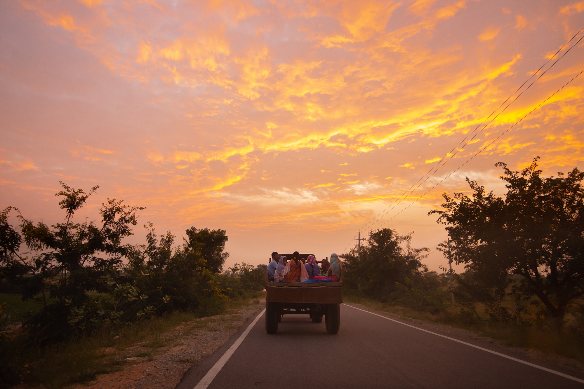 People return home in a tractor in Pavagada. While some have benefitted from the job openings at the solar park, others point at the lack of diversified jobs and training for local communities. Photo by Abhishek N. Chinnaappa/Mongabay.