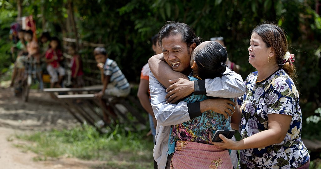 Former enslaved fisher, Myint Naing, left, is embraced by his mother Khin Than, second left, as his sister Mawli Than, right, is overcome with emotion. They were reunited after 22 years in their village in Mon State, Myanmar on May 16, 2015 / Credit: Associated Press, Gemunu Amarasinghe.