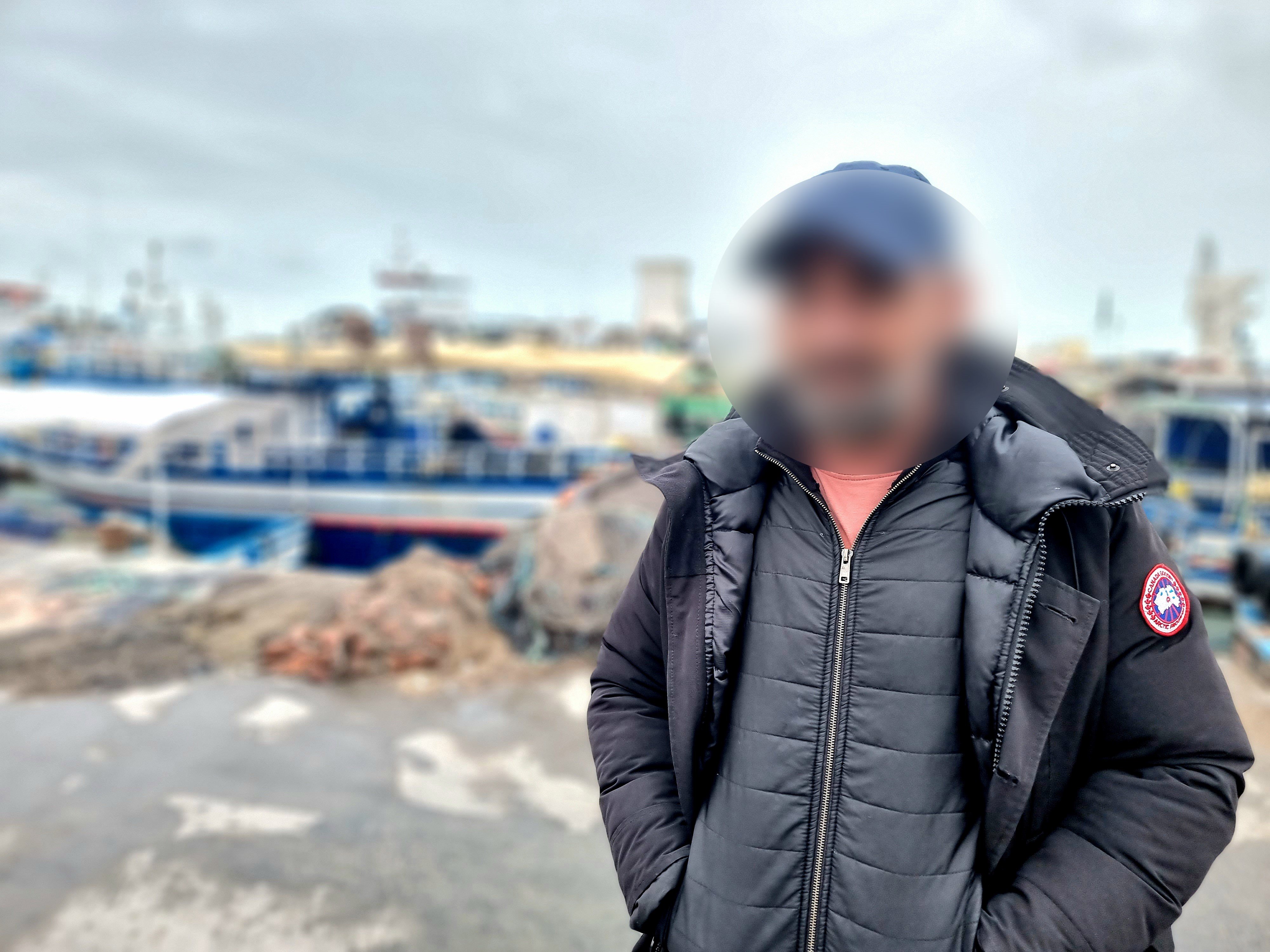 A Tunisian fisherman in a port with a blurred face