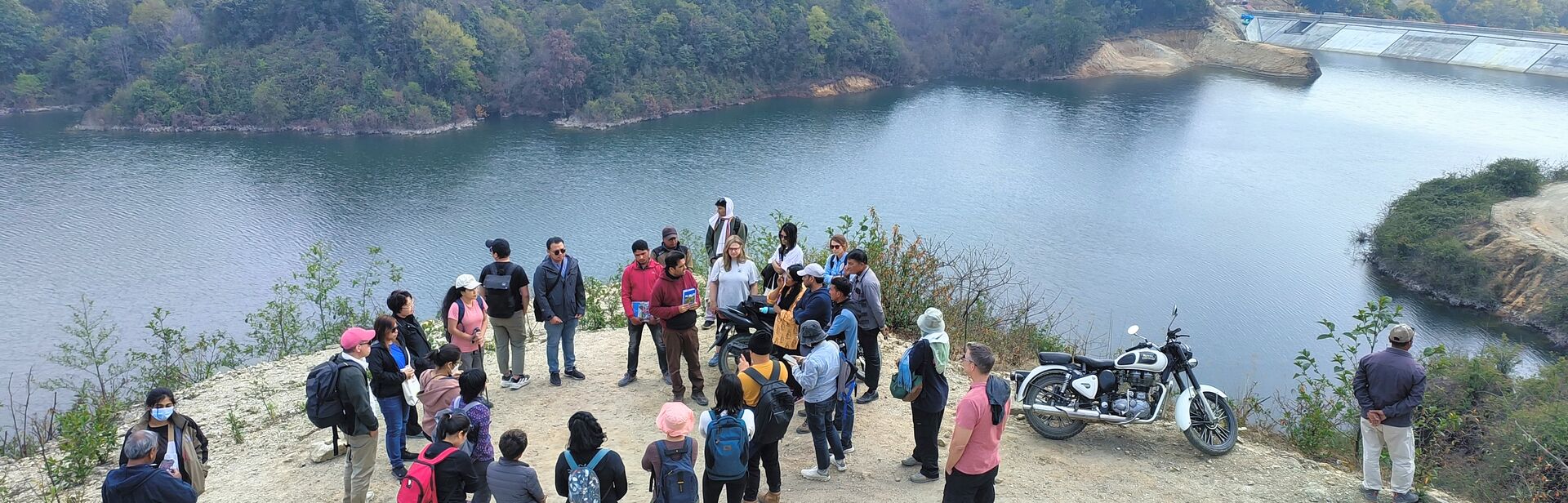 a group of journalists gathered at dhap dam 