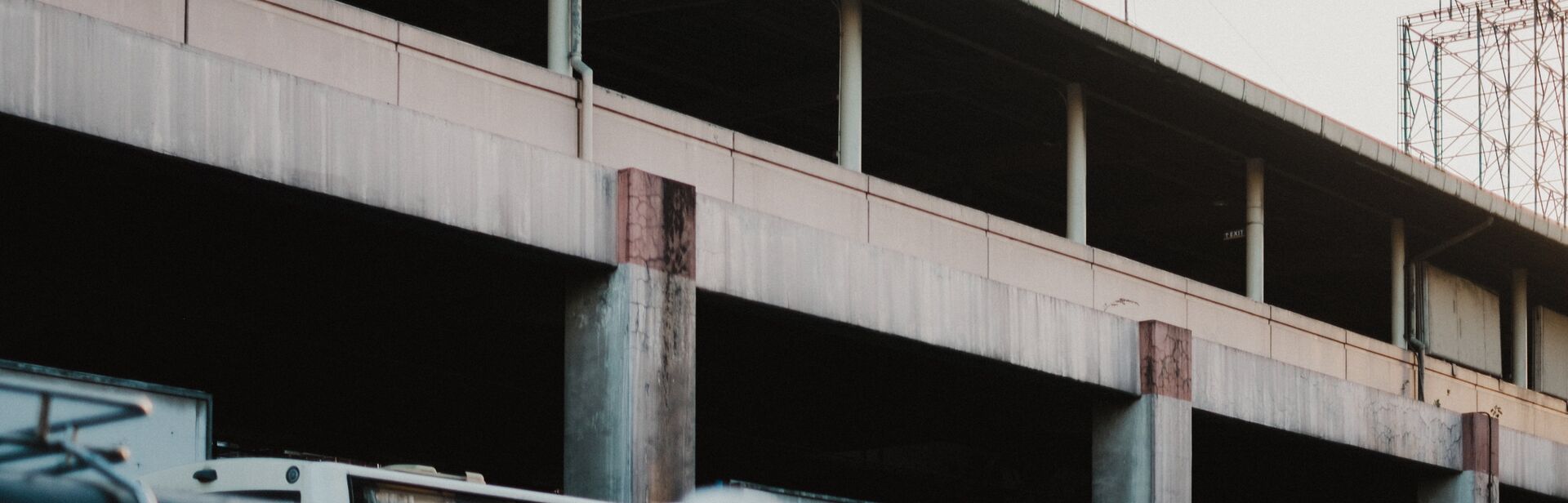 a man walks past a concrete overpass
