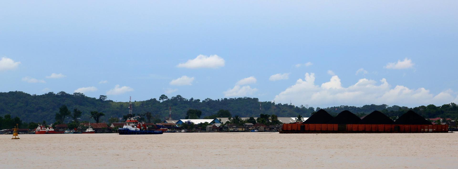 Barges transport coal on the Mahakam river in East Kalimantan, Indonesia