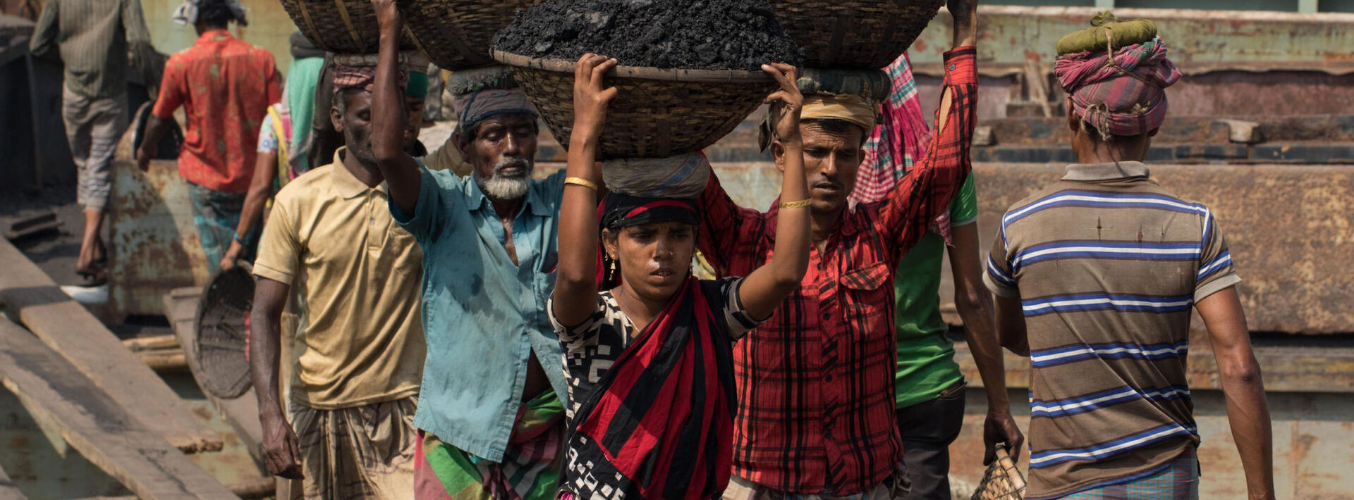 Workers unload coal in Dhaka