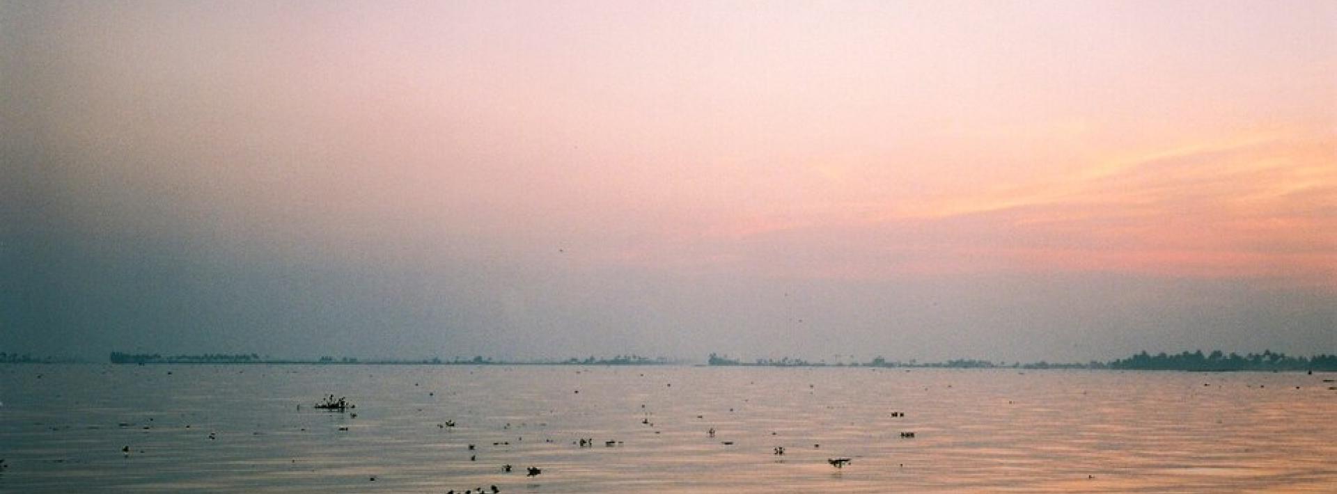 The sun rises over Lake Vembanad in Kerala. Though the region is known for its blazingly hot temperatures, overcast skies during monsoon seasons mean solar power isn’t always reliable.