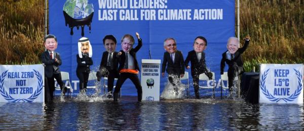 climate activists dressed as world leaders on stage