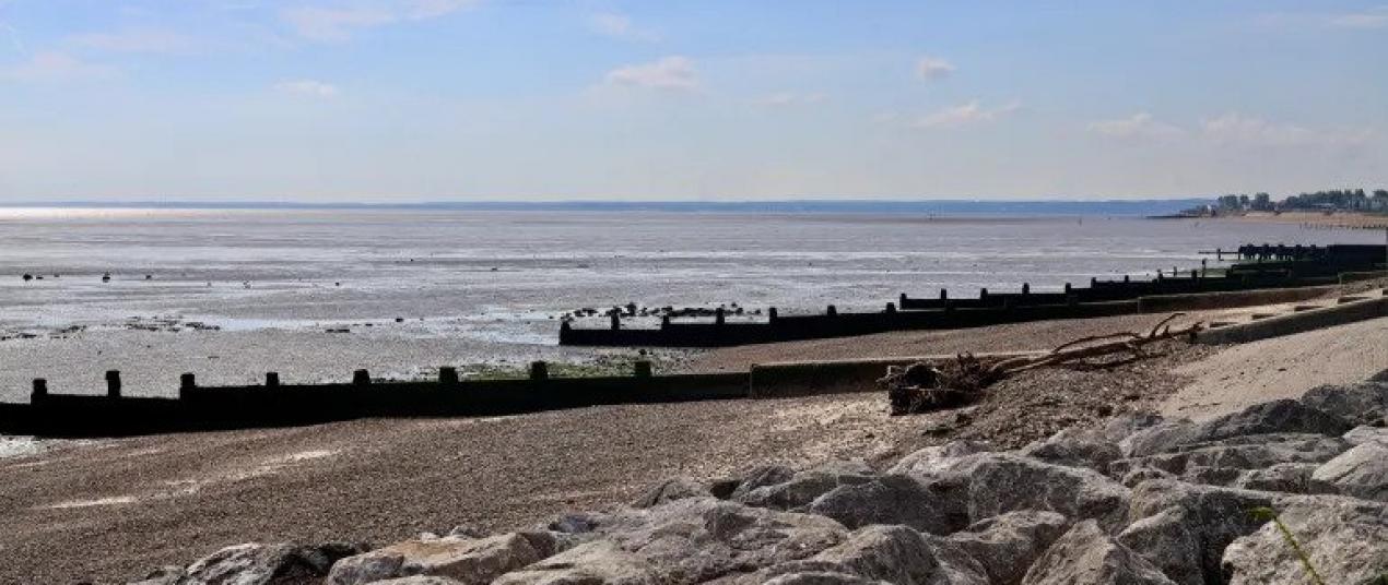 A landscape view of groynes and rock armour on the Eastchurch beach on the Isle of Sheppey in the United Kingdom, where last year the government announced a record $6.2bn investment in flood and coastal defences 