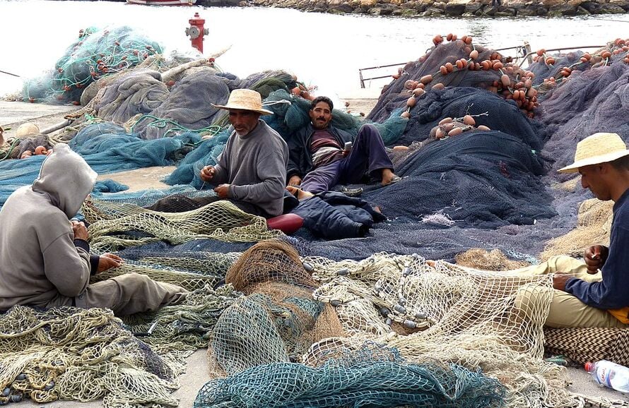 fishermen repairing nets 