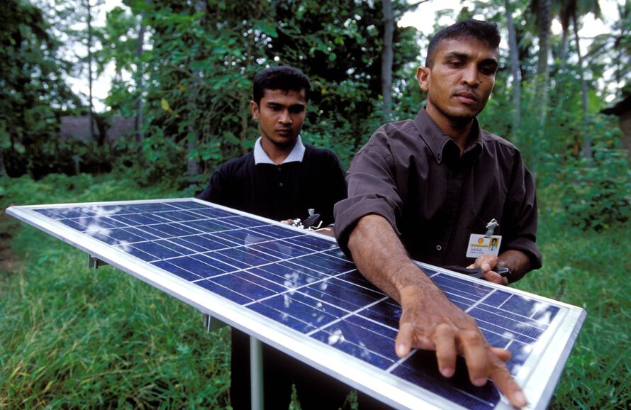 two people hold a solar panel