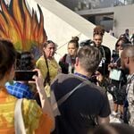 Journalists photograph and interview an Indigenous protest at COP28