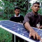 two people hold a solar panel