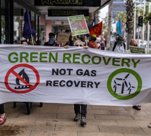 people in the streets protesting with a banner for green recovery in  Australia.