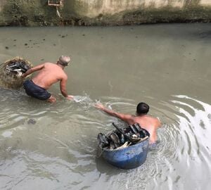 Two men with buckets in polluted water