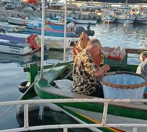 A fisherman on a boat in a port in Tunisia 